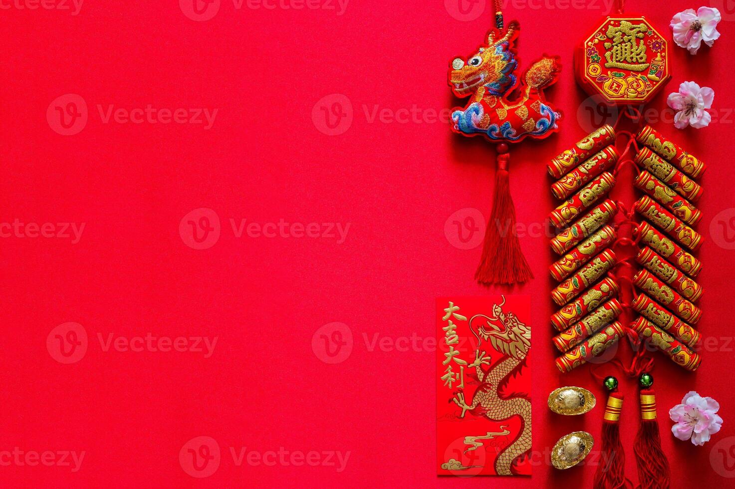 Firecrackers for Chinese new year word mean wealth, blessing with gold ingots word mean wealth, red envelope packet word mean good luck and good fortune and pendant dragon on red background. photo