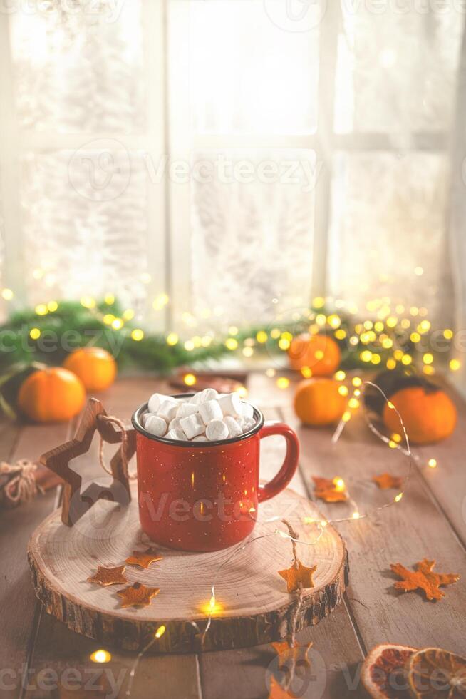 Cute cozy winter composition. red mug, marshmallows, oranges and Christmas lights. photo