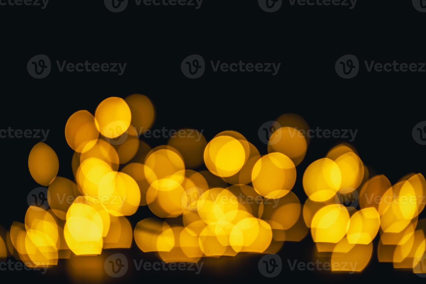 background, texture. Yellow round bokeh on black background photo