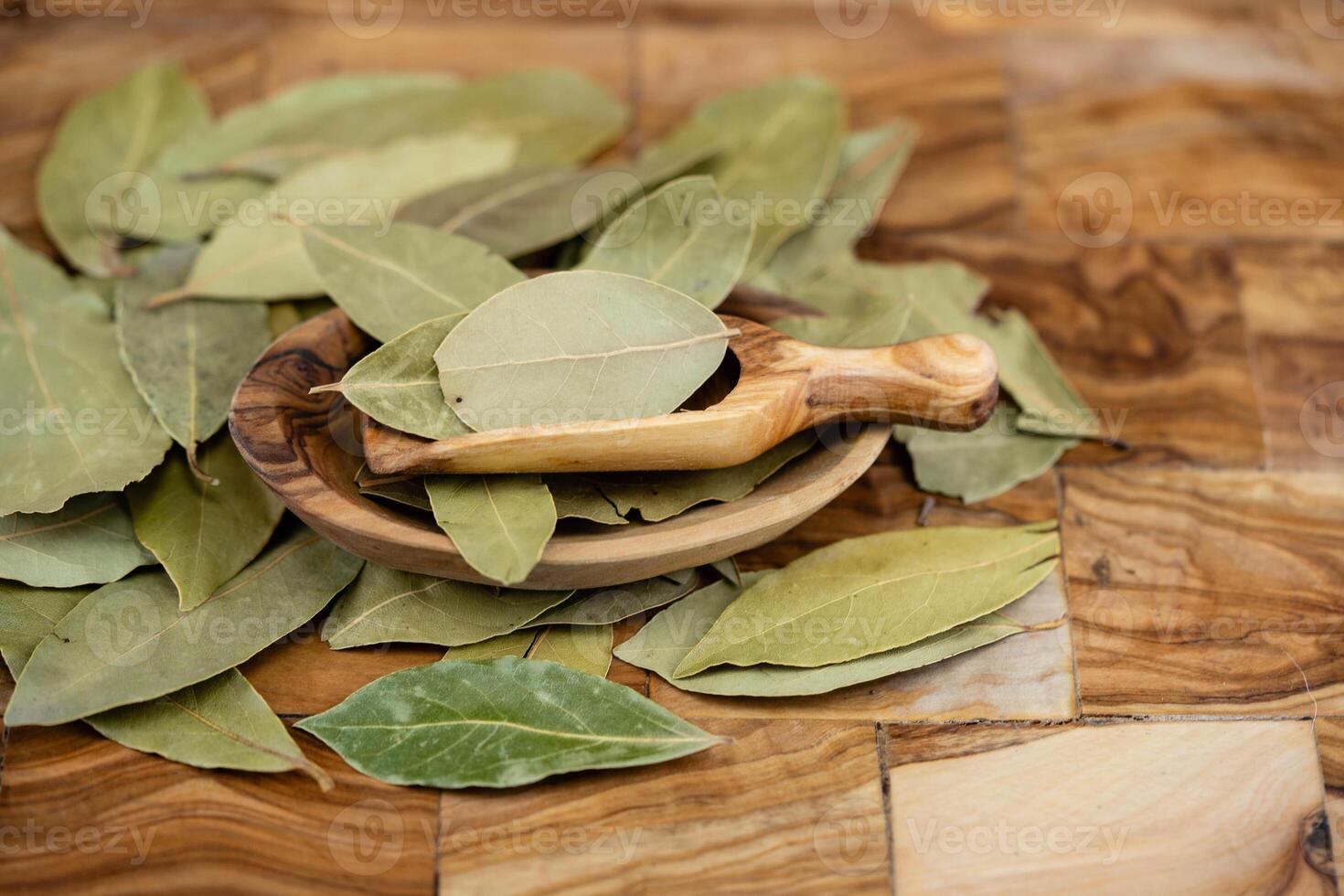 Bay leaves and on olive wood photo