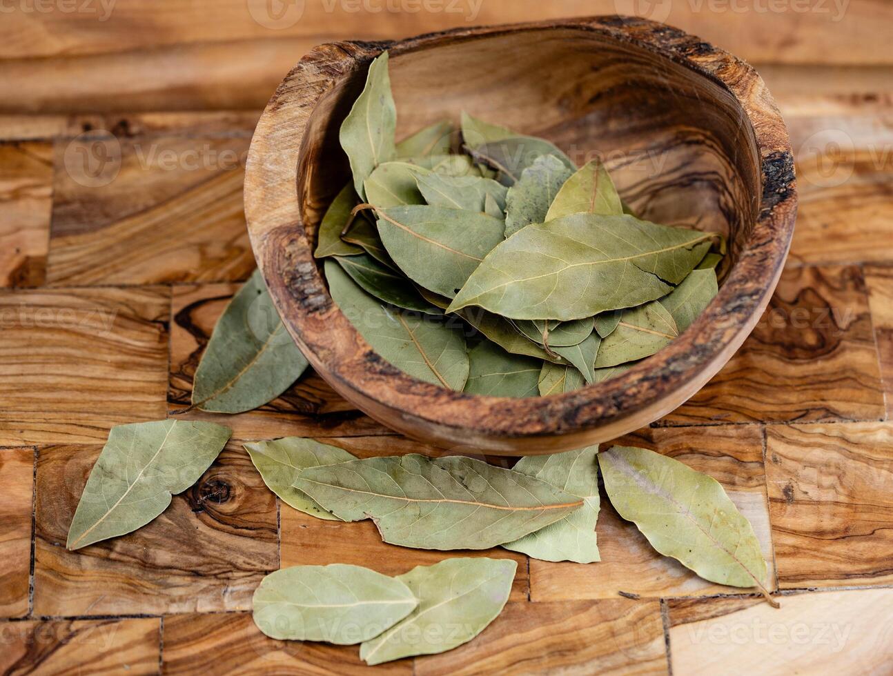 Bay leaves and on olive wood photo