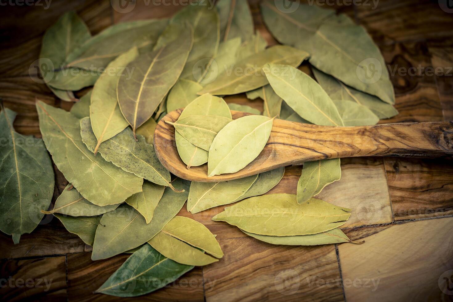 Bay leaves and on olive wood photo