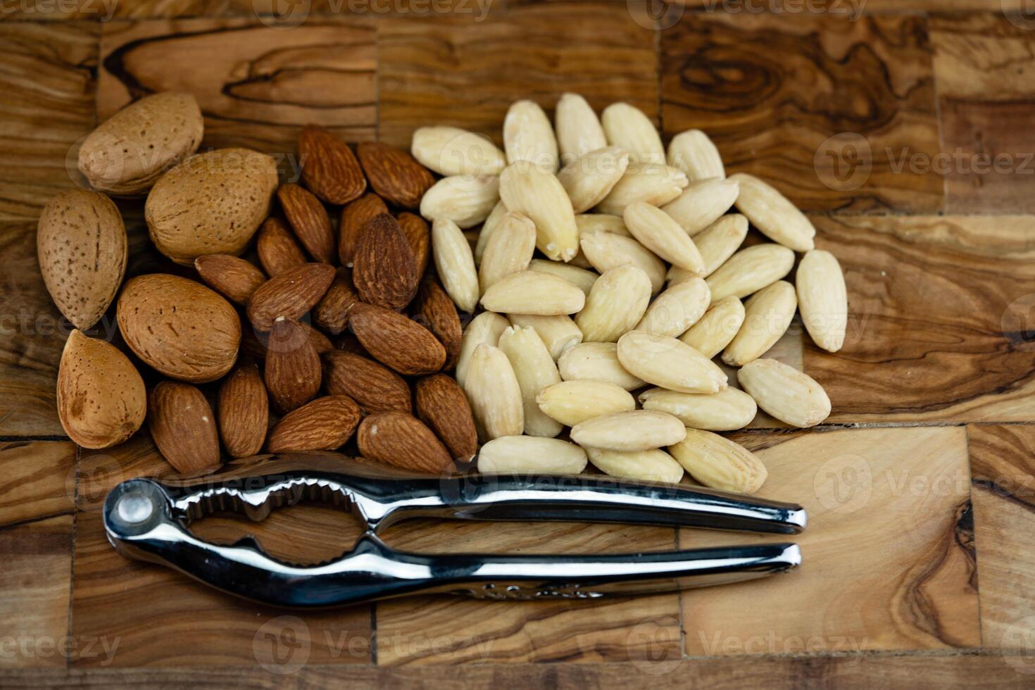 fresh blanched almond on olive wood photo