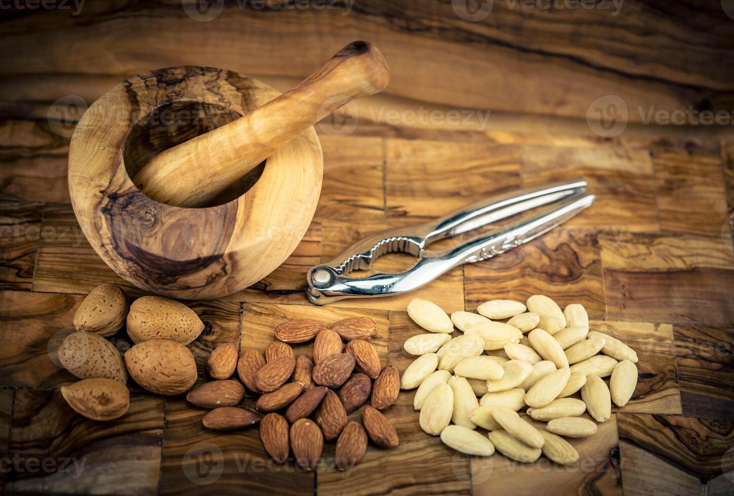 fresh blanched almond on olive wood photo