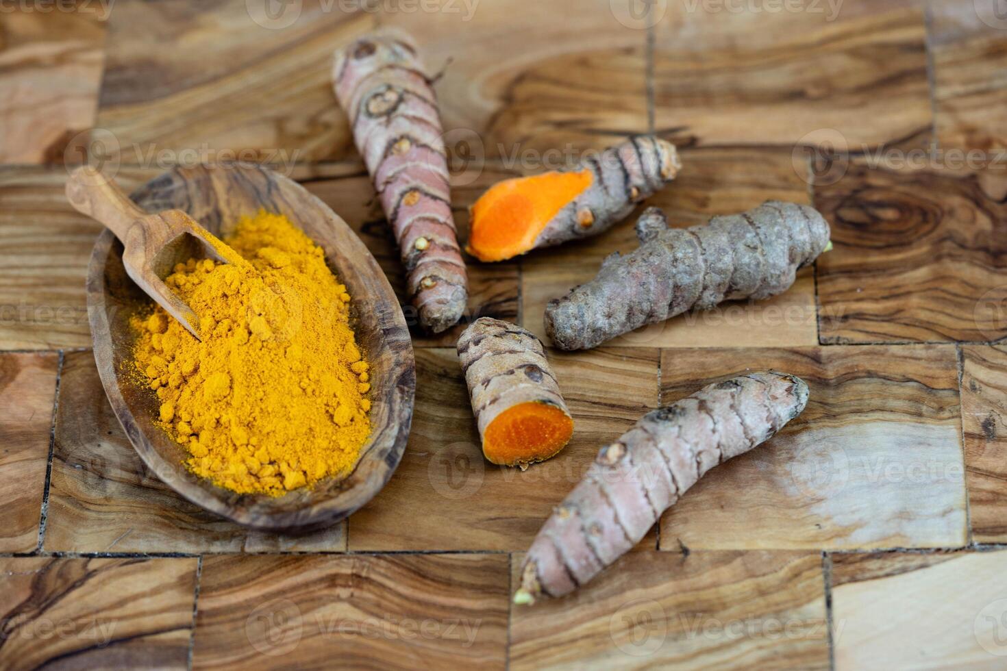 Turmeric Curcuma longa the yellow spice on olive wood photo