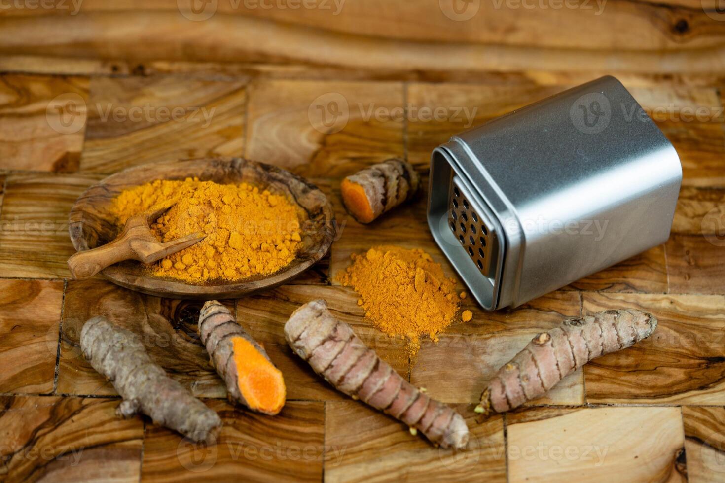 Turmeric Curcuma longa the yellow spice on olive wood photo