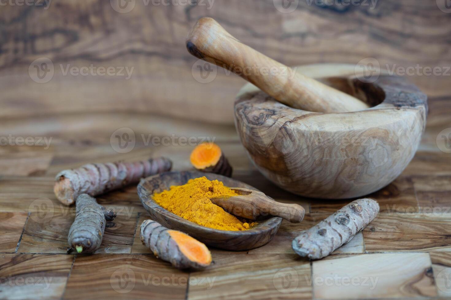 Turmeric Curcuma longa the yellow spice on olive wood photo