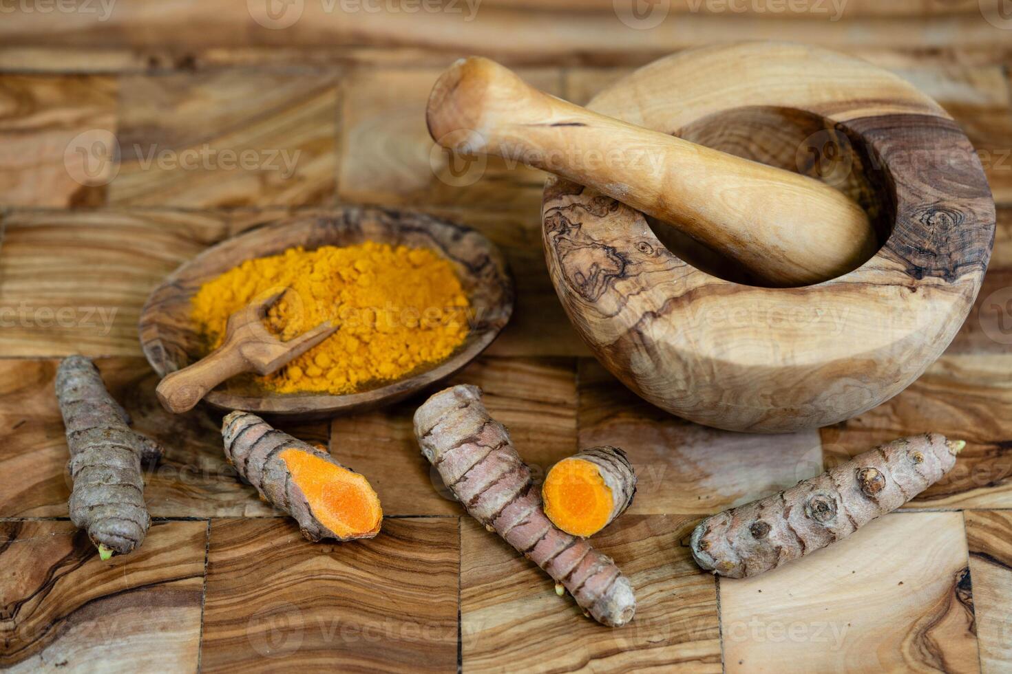 Turmeric Curcuma longa the yellow spice on olive wood photo