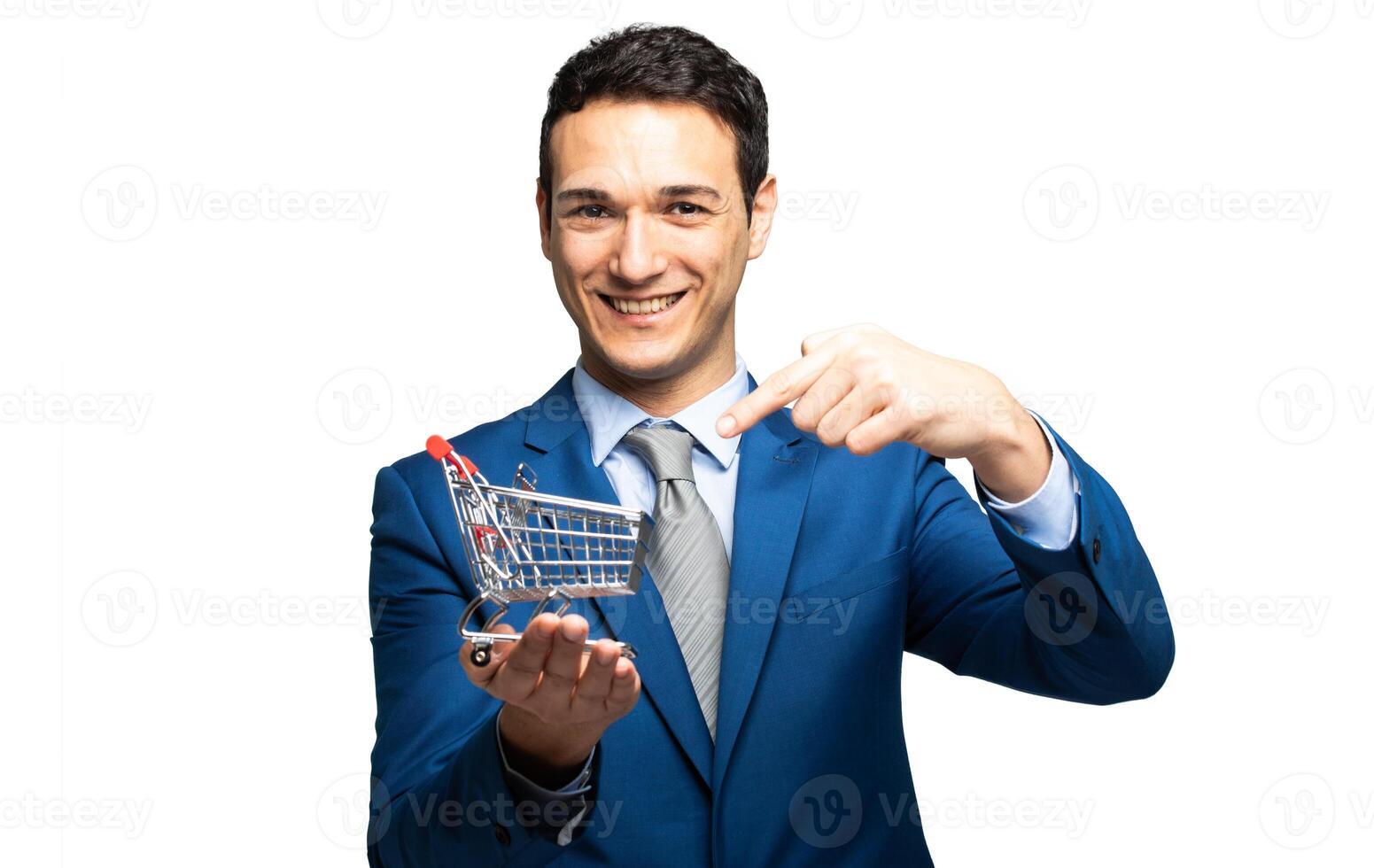 Smiling businessman holding a mini shopping cart photo