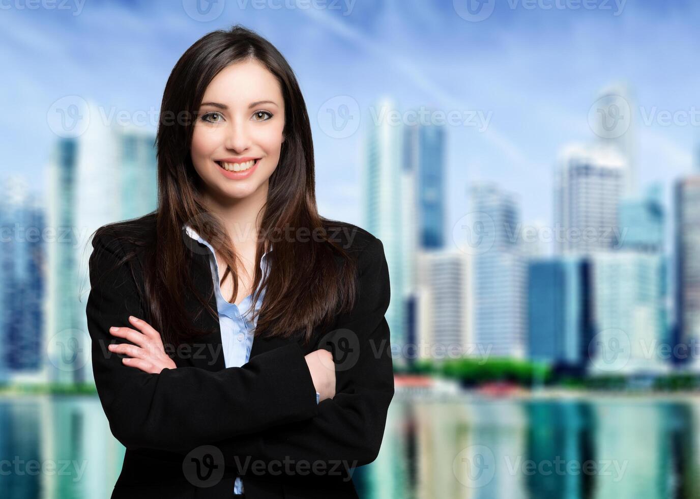 Businesswoman portrait outdoor against a modern city skyline in the background photo