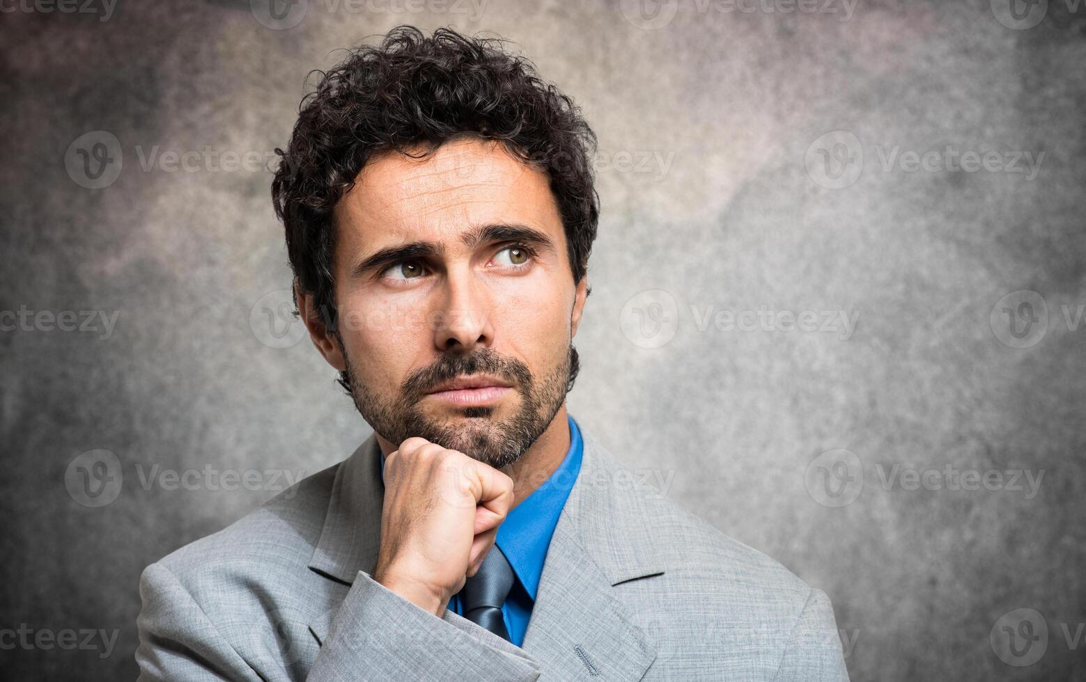 Pensive businessman against a grungy background photo