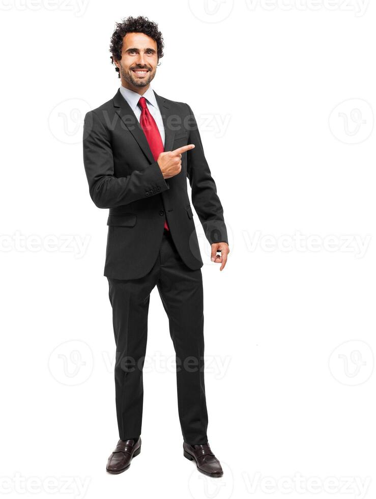 Handsome businessman pointing his finger to the right photo