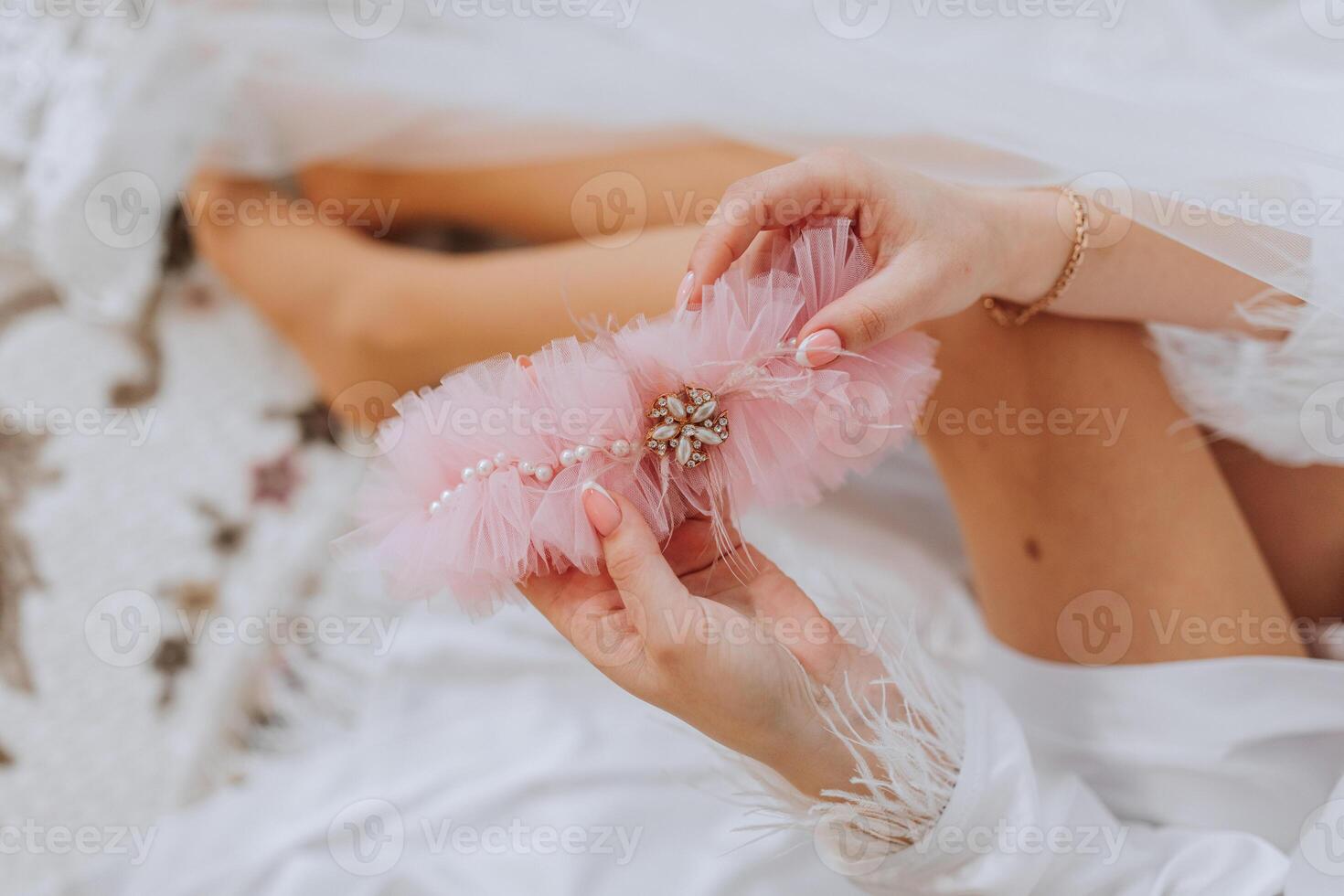 pink garter of the bride. Beautiful underwear. The morning of the bride in detail. Preparation for the wedding ceremony photo