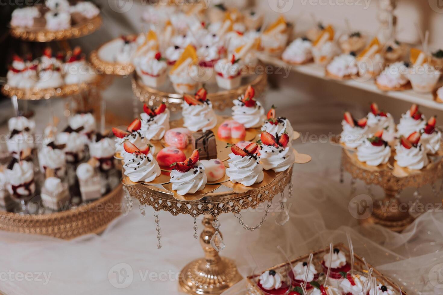 Almond cookies and various sweet cakes for a wedding banquet. A delicious reception, a luxurious ceremony. Table with sweets and desserts. Delicious colorful French desserts on a plate or table. photo