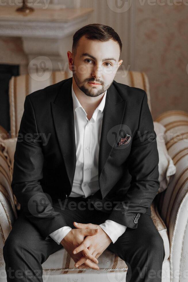 portrait of a handsome man in a hotel room in the morning. Preparation for an event or a new working day. New opportunities, acquaintances. Close-up portrait photo