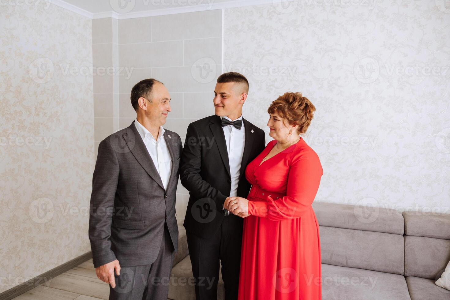 photo with parents at the wedding. Happy parents rejoice for their son who will soon get married. Touching moments at the wedding