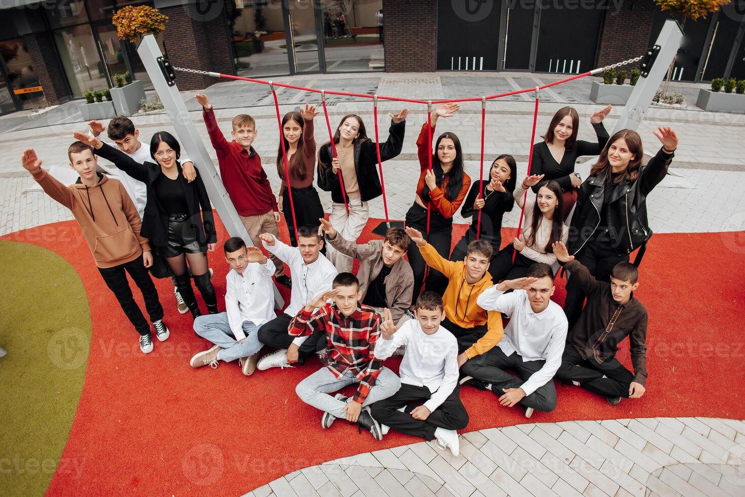 Group of many happy teenagers dressed in casual clothes having fun and having fun near college. Concept of friendship, moments of happiness. School friendship photo