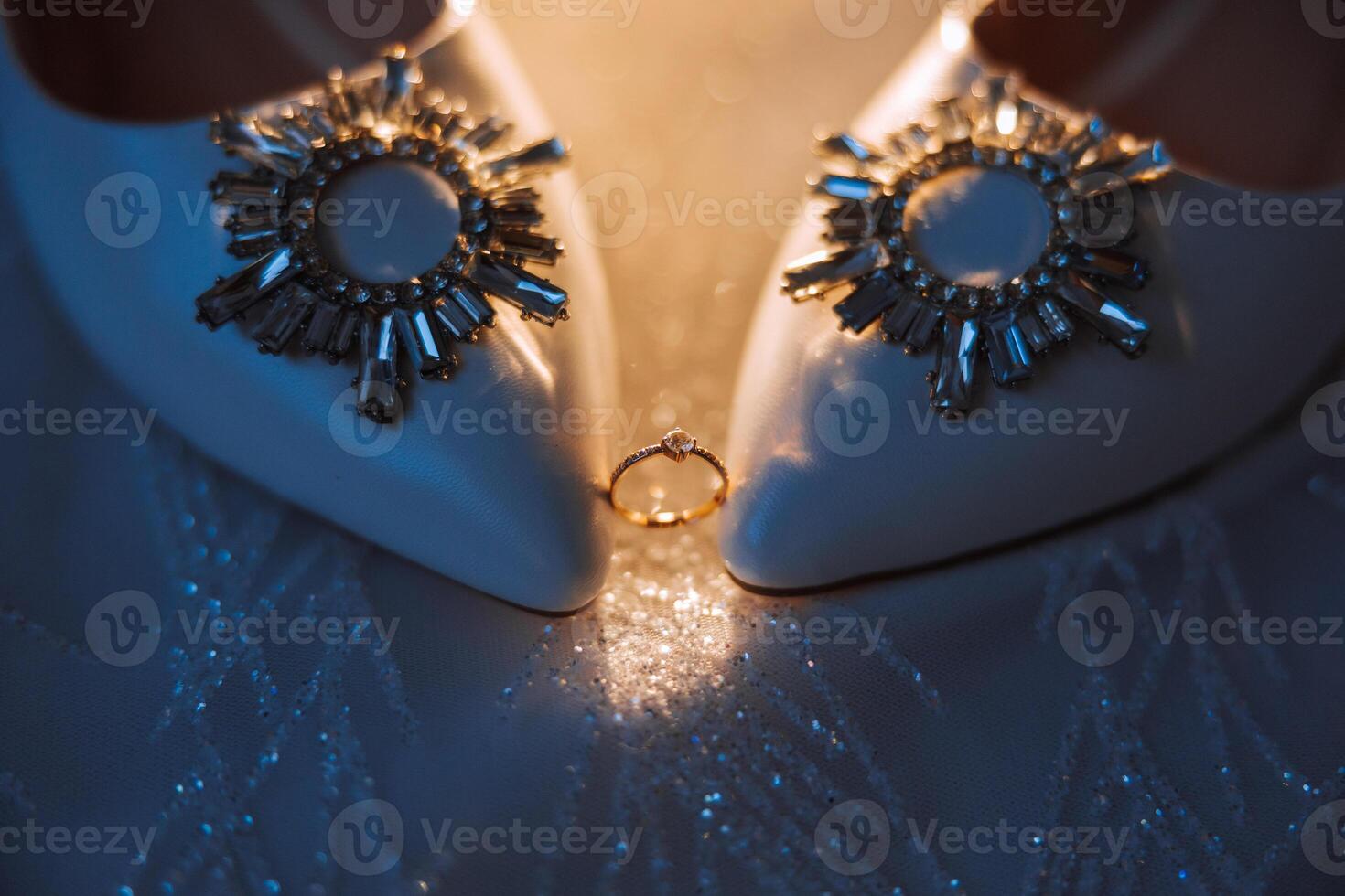 Details of the bride. Beauty is in the details. High-heeled bridal shoes. Gold wedding ring with a diamond. Perfumes. Earrings Wedding in details. photo