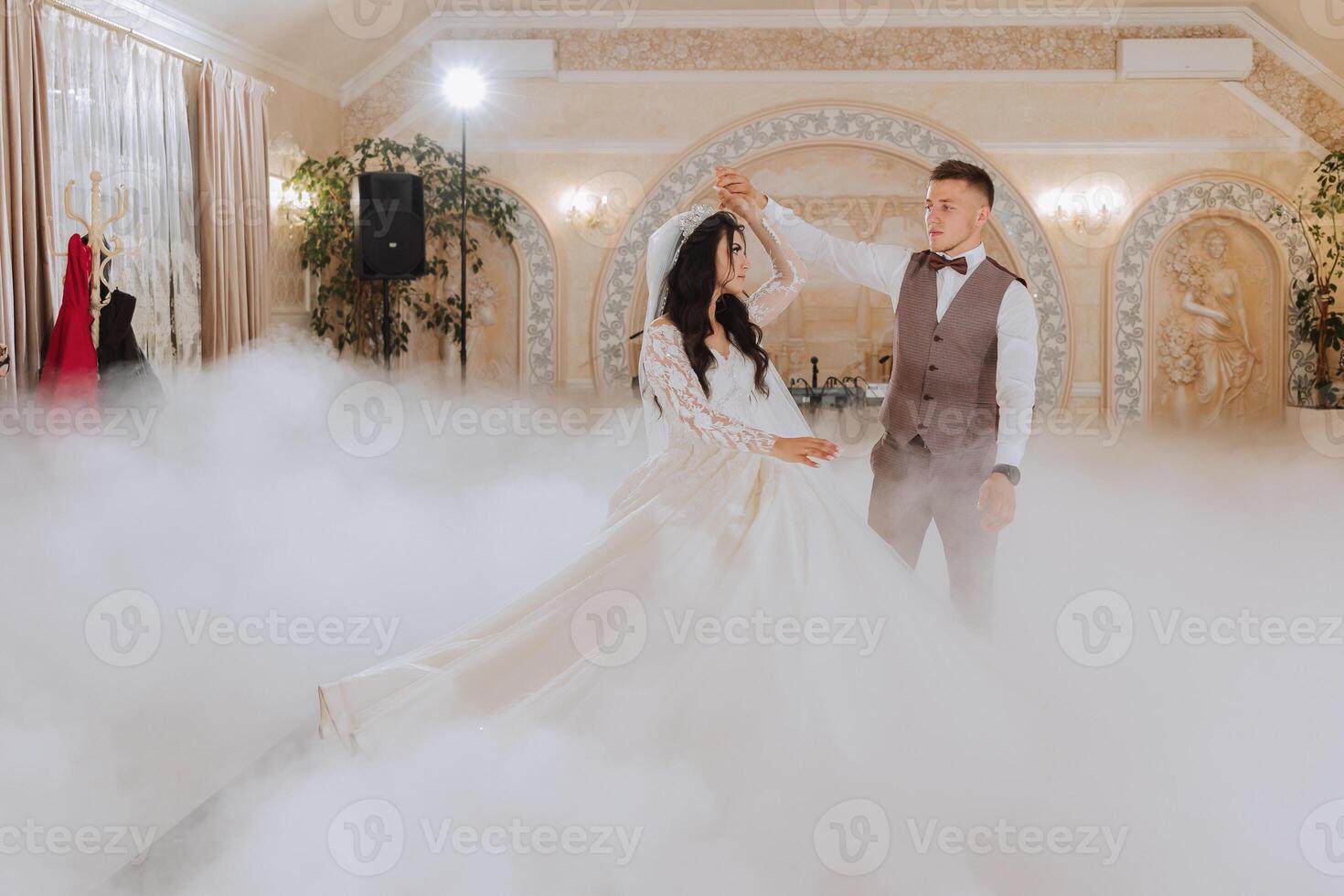 the wedding of the bride and groom in an elegant restaurant with great light and atmosphere. The first dance of the bride and groom. photo