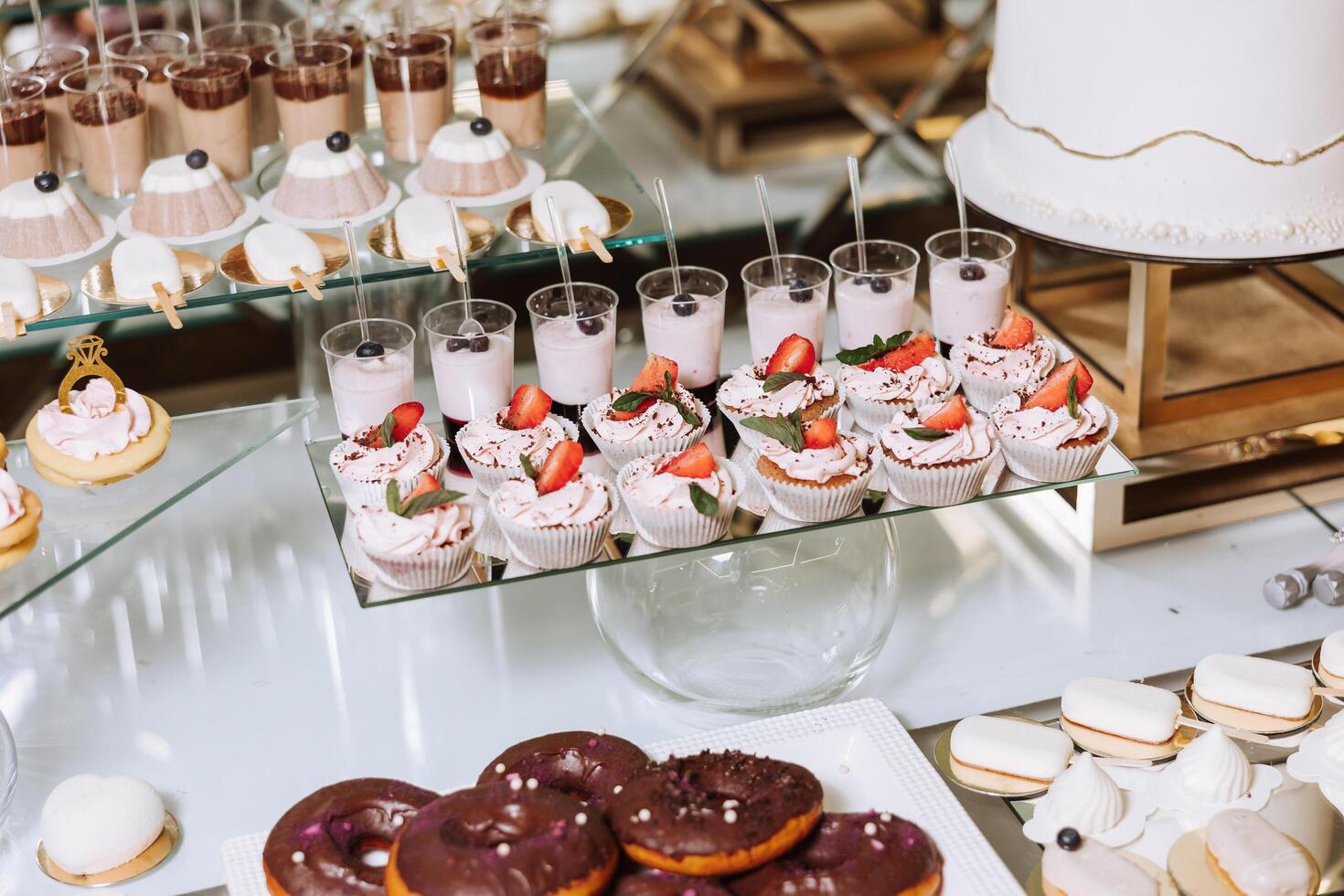 Almond cookies and various sweet cakes for a wedding banquet. A delicious reception, a luxurious ceremony. Table with sweets and desserts. Delicious colorful French desserts on a plate or table. photo