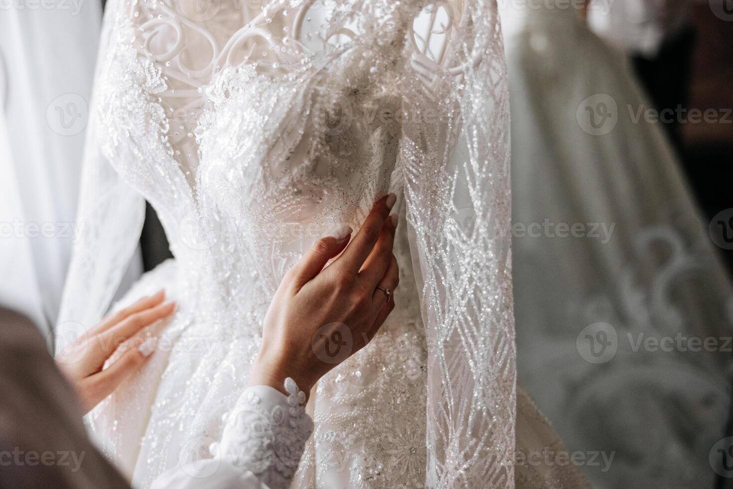 Bedroom interior with wedding dress prepared for the ceremony. A beautiful lush wedding dress on a mannequin in a hotel room. photo