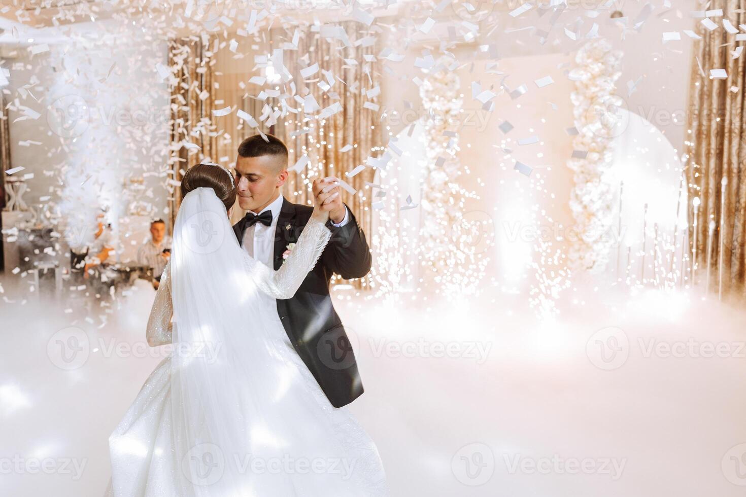 the wedding of the bride and groom in an elegant restaurant with great light and atmosphere. The first dance of the bride and groom. photo