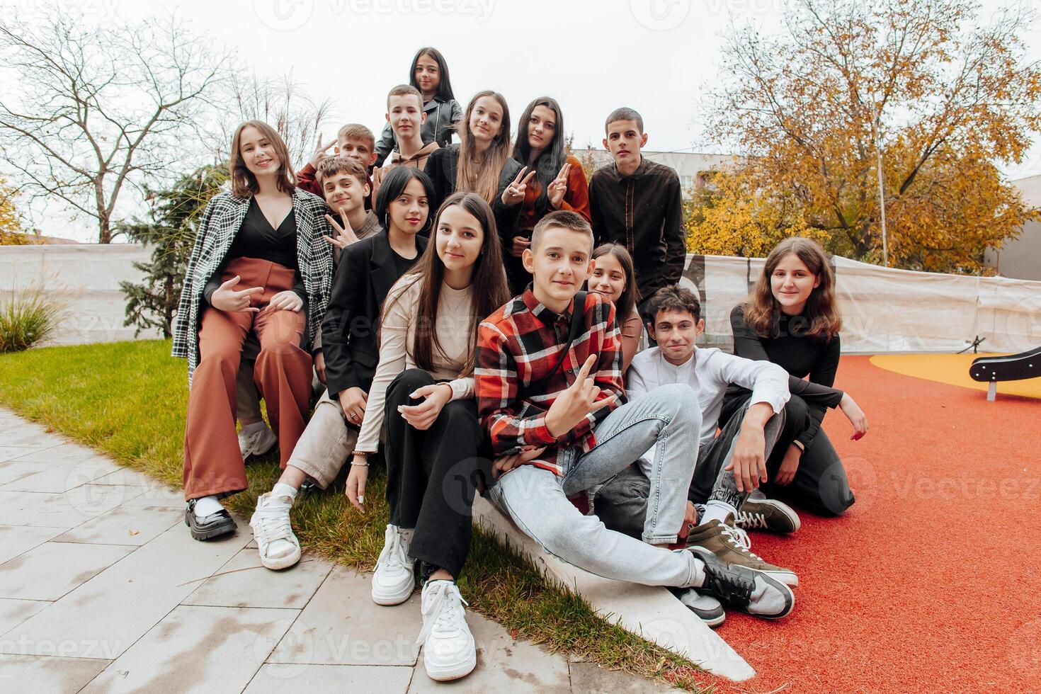 friendship, movement, action, freedom and people concept - group of happy teenagers or school friends posing and having fun outdoors on background of beautiful place or college. photo