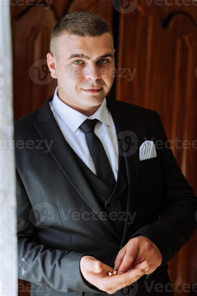 A groom holding wedding rings in his hands. Wedding traditions. Golden rings lie on the palm of a person. photo