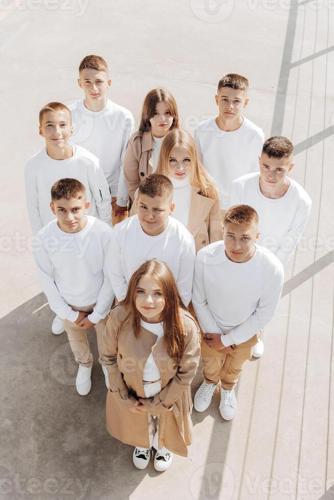 friendship, movement, action, freedom and people concepts - group of happy teenage students or school friends posing and having fun outdoors on beautiful place background. photo