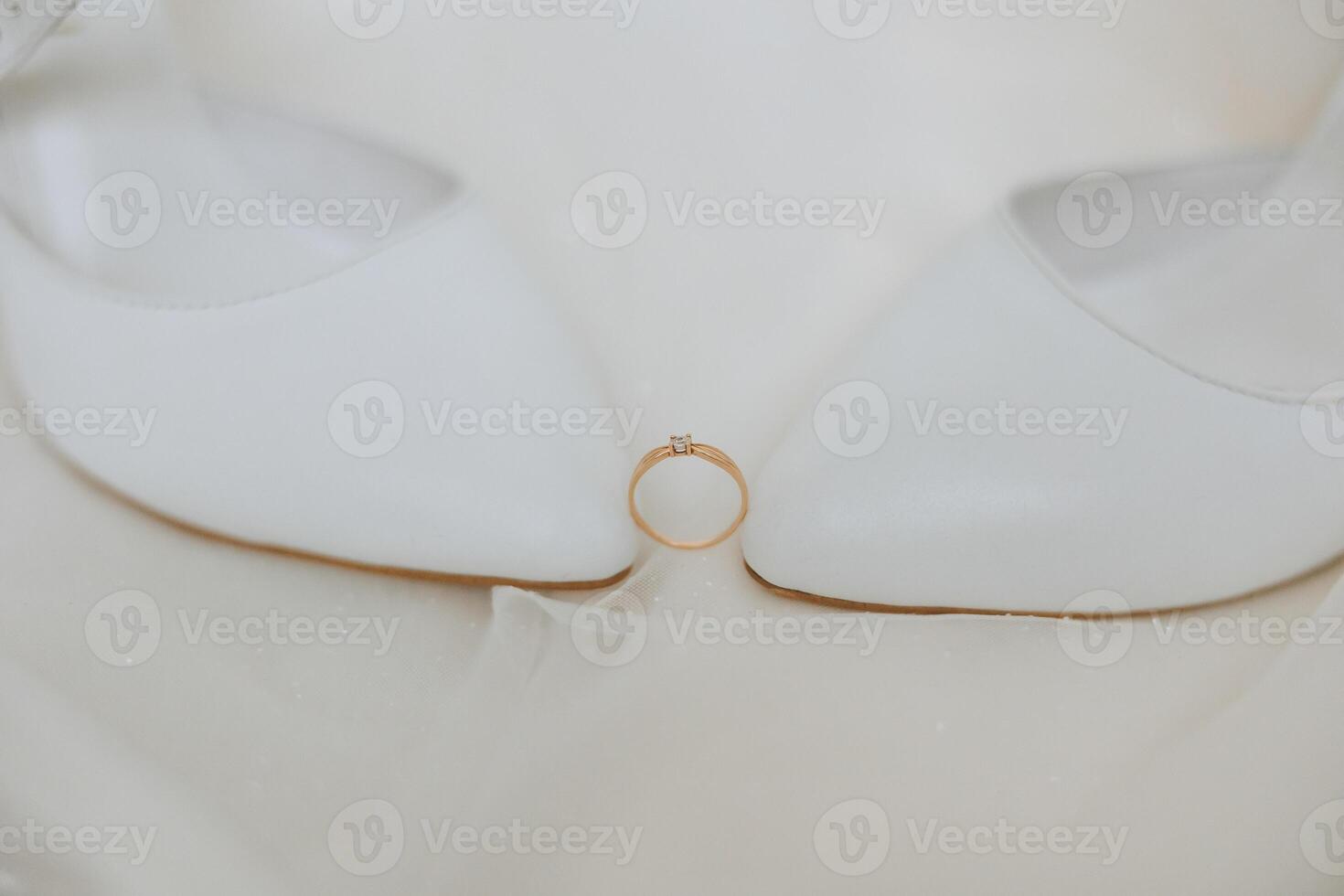 Details of the bride. Beauty is in the details. High-heeled bridal shoes. Gold wedding ring with a diamond. Perfumes. Earrings Wedding in details. photo