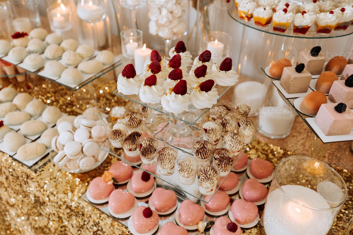 Candy bar for a wedding. Candy bar standing festive table with desserts, cupcakes and macarons. Beautiful and tasty. photo