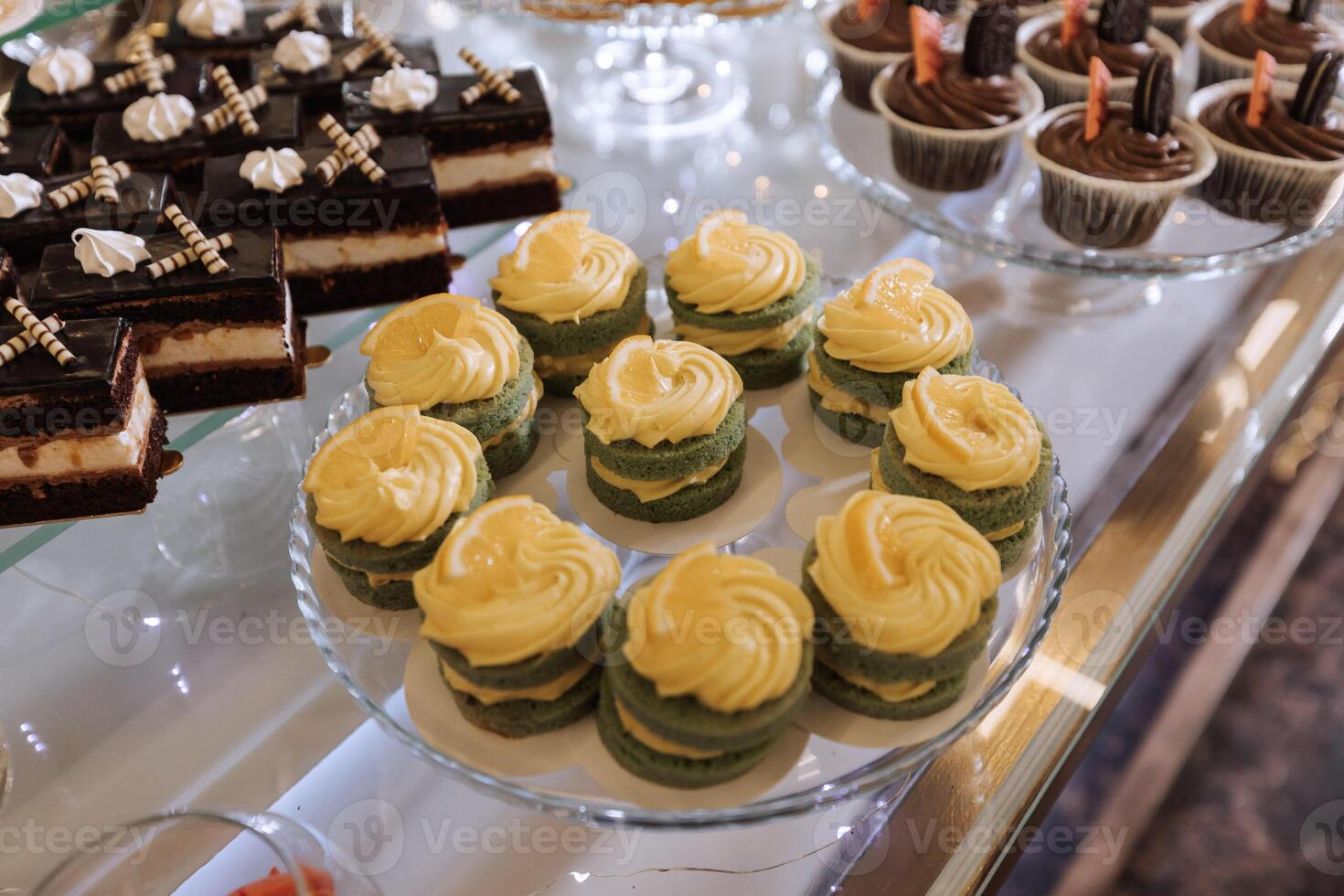 A delicious wedding. Cupcakes, cakes. Candy bar for a banquet. Celebration concept. Fashionable desserts. Table with sweets, candies. Fruits photo