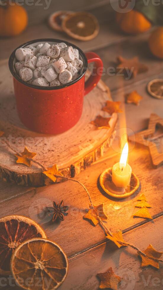 Cute cozy winter composition. red mug, marshmallows, oranges and Christmas lights. photo