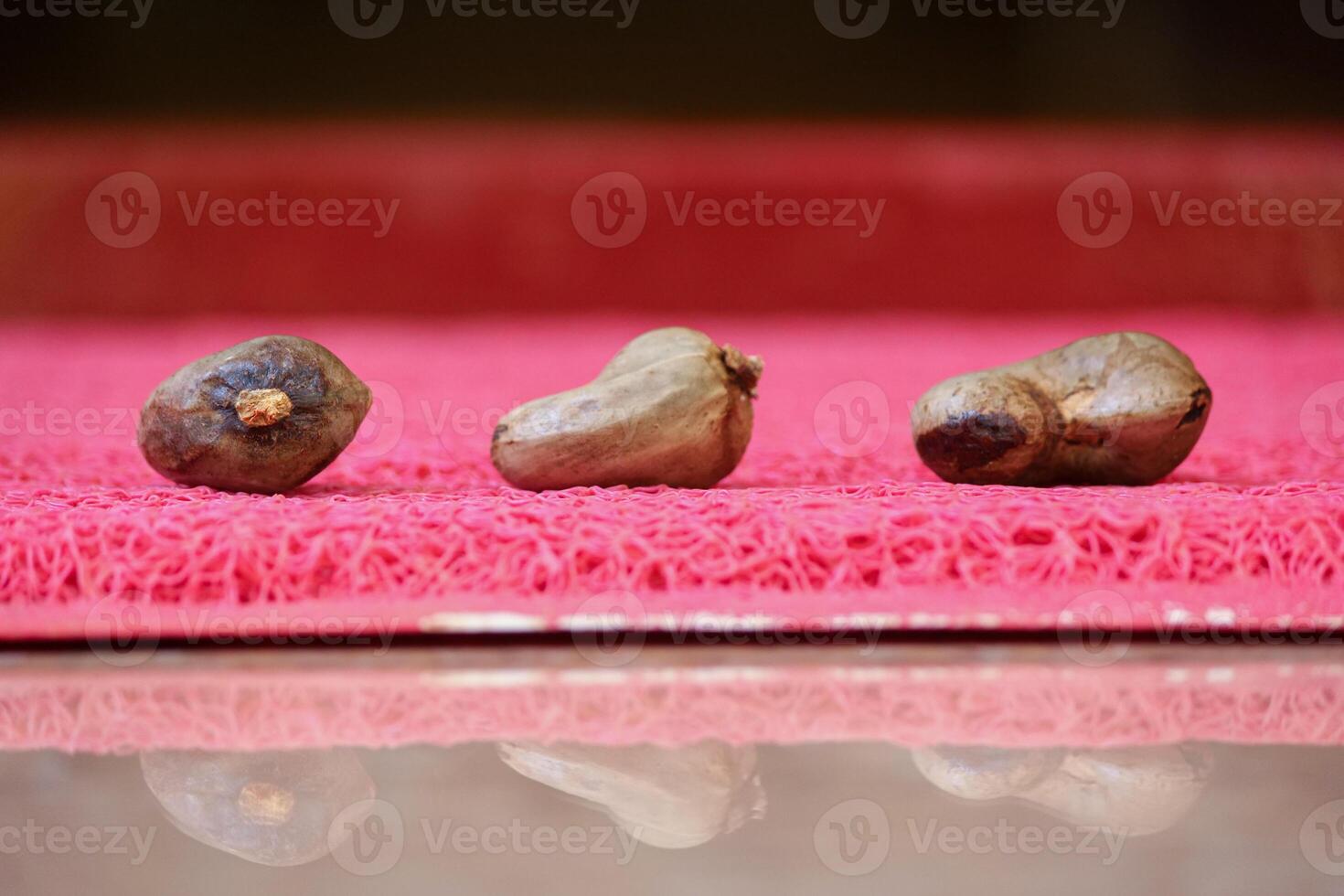 Close Up of Cashew Nuts Placed on The Matte photo