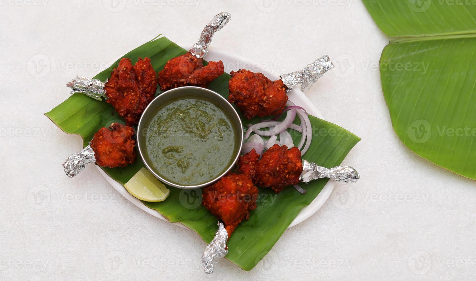 Chicken Lollipop Plate Served in Banana Leaf, Indian Cuisine Chicken Lollipop, Nonveg Food Chicken Lollipop photo