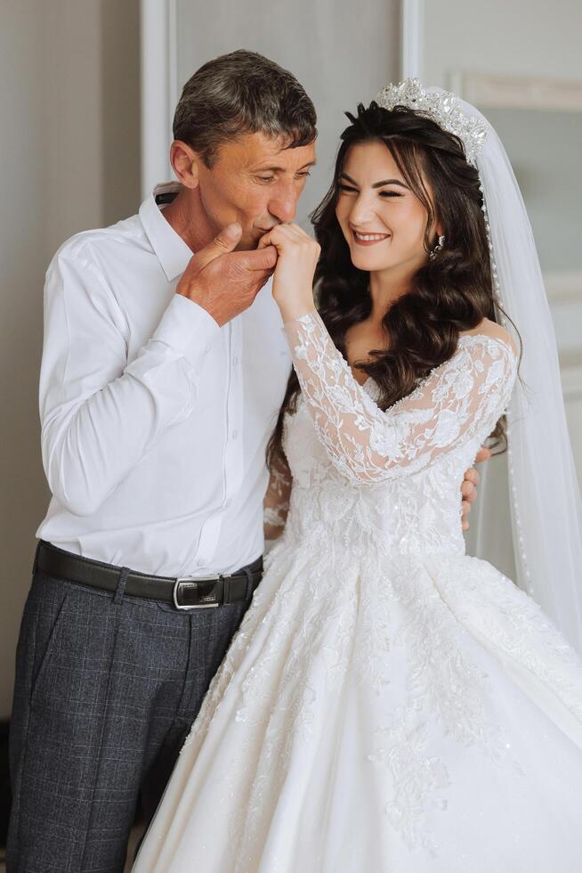 A beautiful bride with her father on her wedding day. The best moments of the wedding day. Daughter and father. photo