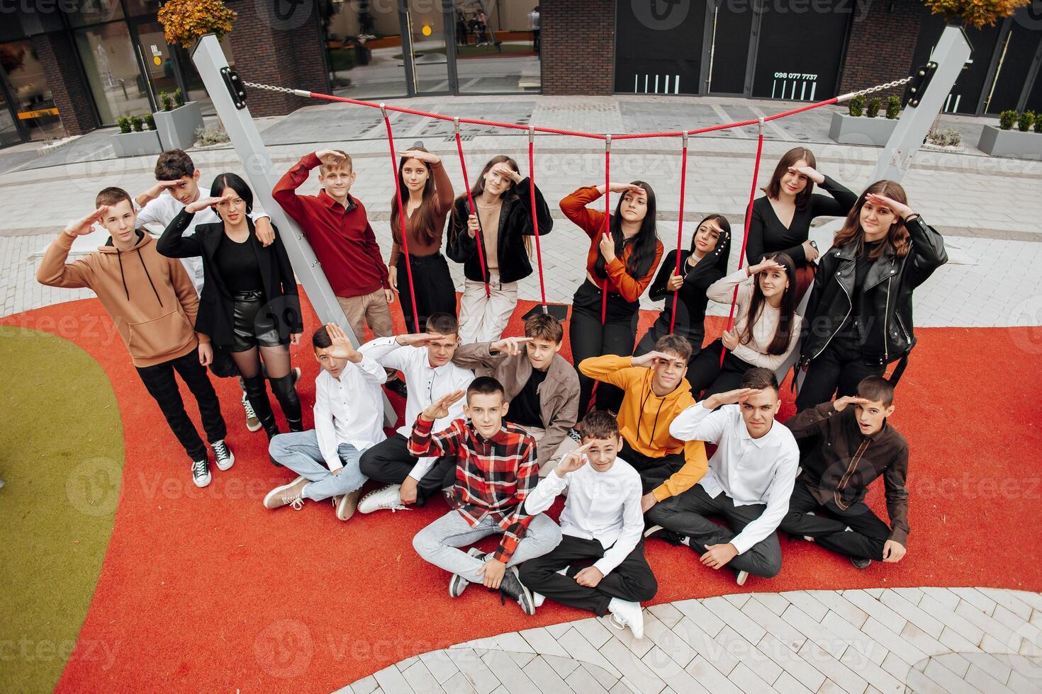 friendship, movement, action, freedom and people concept - group of happy teenagers or school friends posing and having fun outdoors on background of beautiful place or college. photo