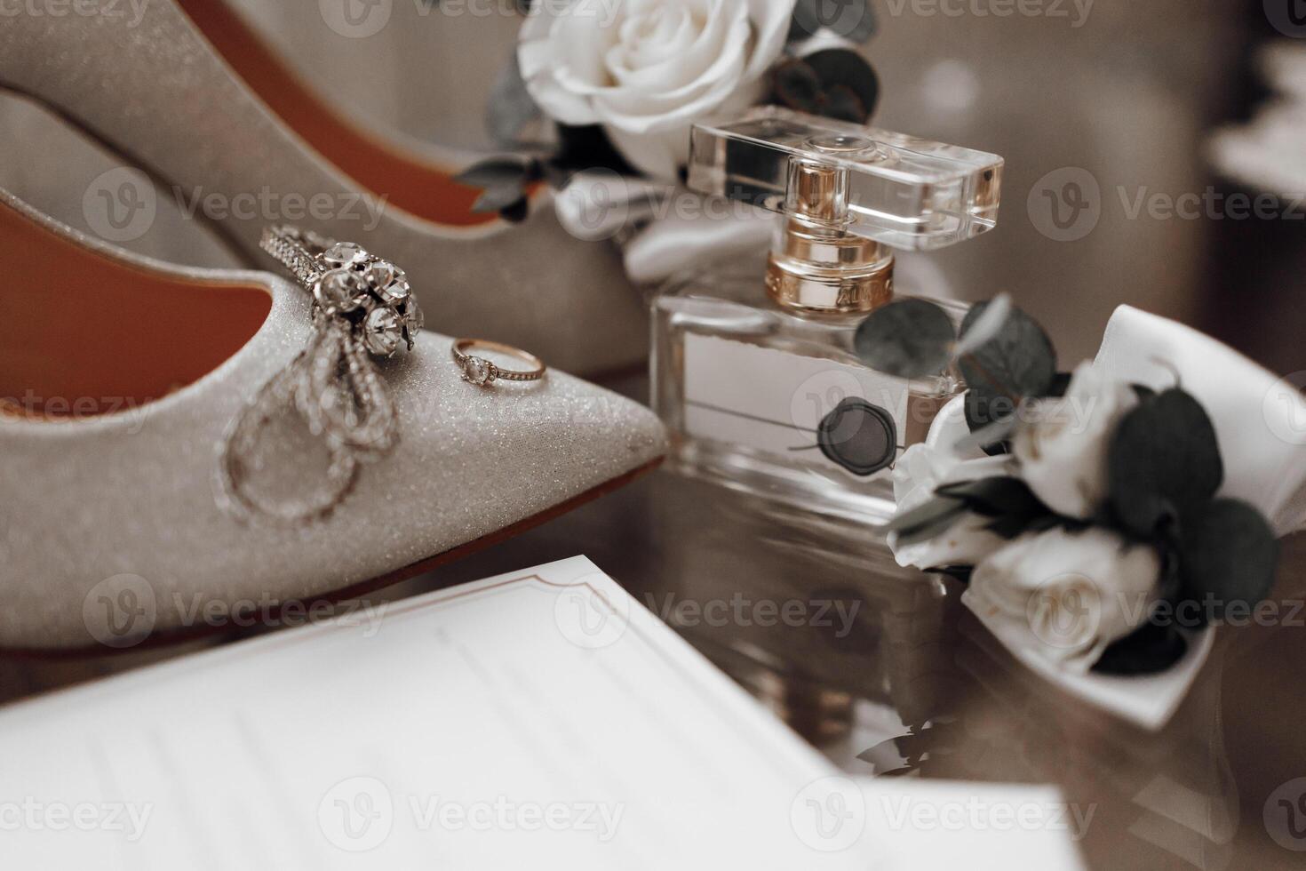 The bride's wedding ring is on the shoes, Perfume. Wedding details photo