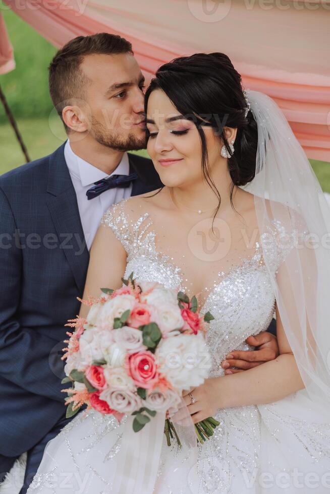 Wedding. Love and couple in garden for wedding. Celebration of ceremony and commitment. Save the date. Trust. The bride and groom embrace. Smile and love. Photo of happy and in love brides and grooms.