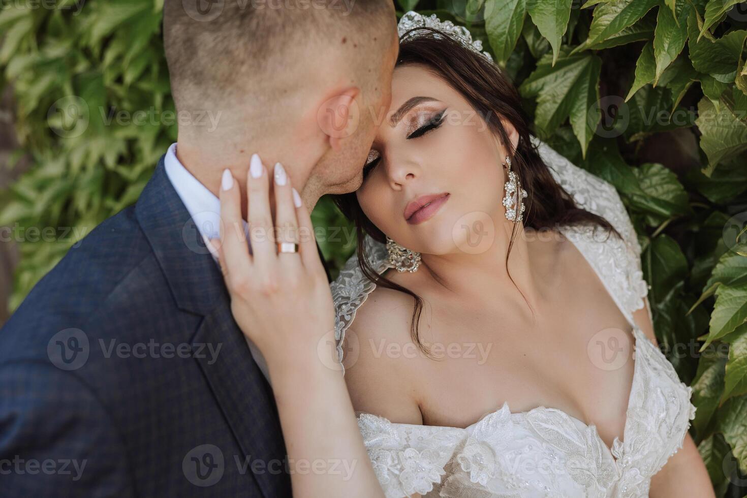 Wedding. Love and couple in garden for wedding. Celebration of ceremony and commitment. Save the date. Trust. The bride and groom embrace. Smile and love. Portrait of happy bride and groom. photo