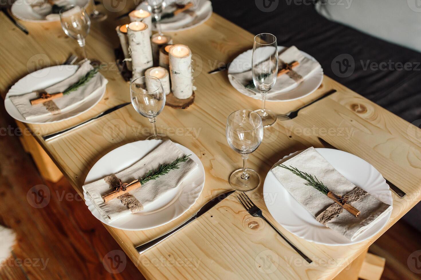 beautiful table setting and cutlery on a wooden table at a wedding or dinner. stylish table decorations photo