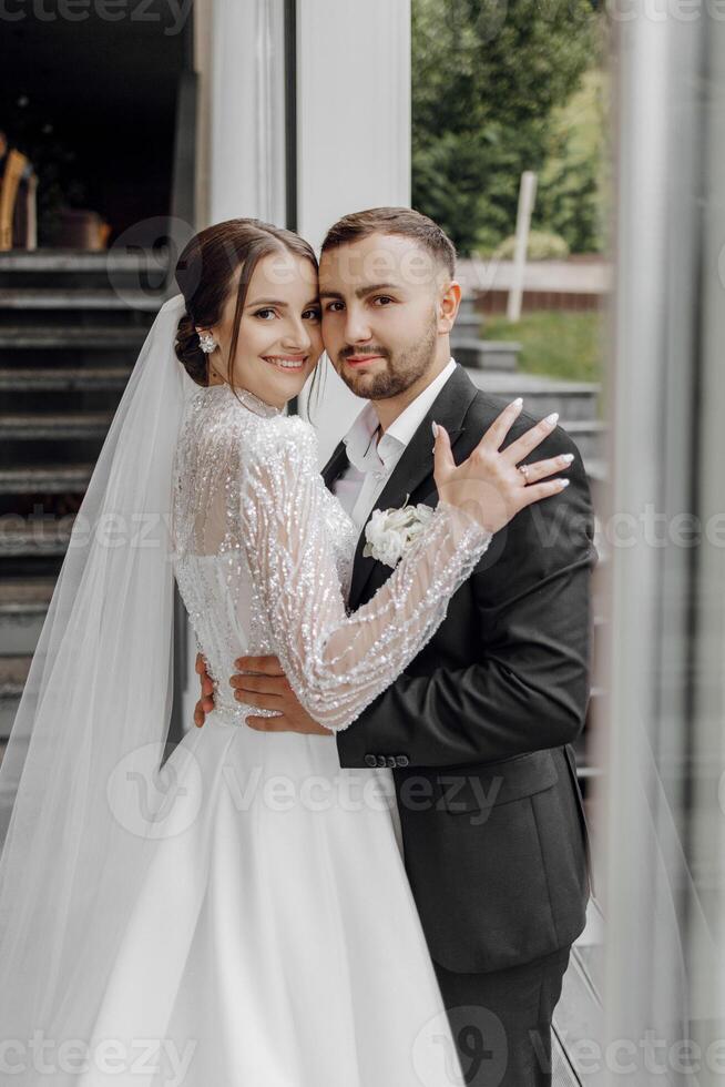 Portrait of happy wife and husband hugging in restaurant and smiling. Sincere feelings of two young people. The concept of true undying love. photo