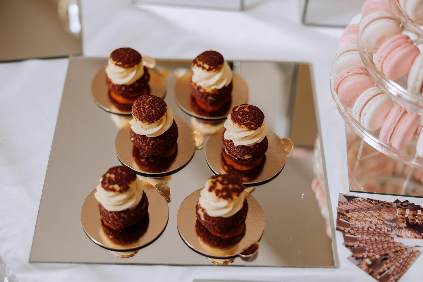 Almond cookies and various sweet cakes for a wedding banquet. A delicious reception, a luxurious ceremony. Table with sweets and desserts. Delicious colorful French desserts on a plate or table. photo