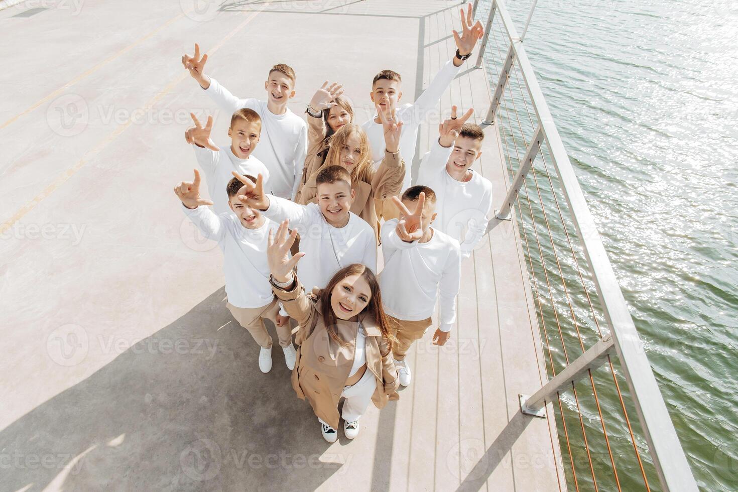 friendship, movement, action, freedom and people concepts - group of happy teenage students or school friends posing and having fun outdoors on beautiful place background. photo