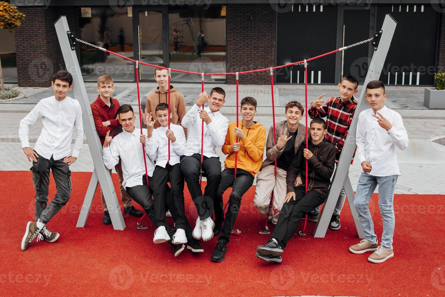 friendship, movement, action, freedom and people concept - group of happy teenagers or school friends posing and having fun outdoors on background of beautiful place or college. photo