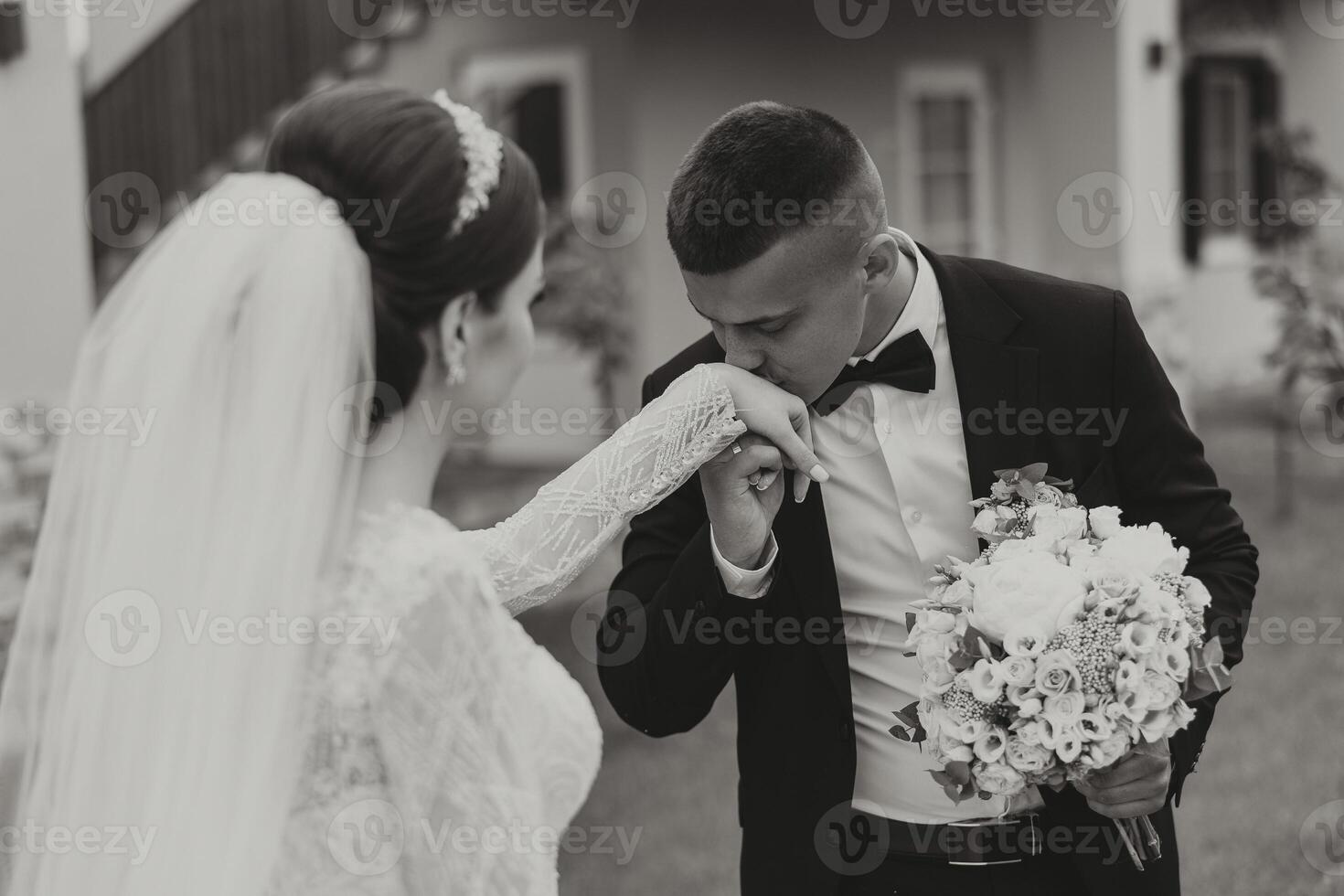 She told him yes. A young man kisses his wife's hand with a gold ring, proposing marriage. Engagement of a young couple in love. Concept of love and unity. photo