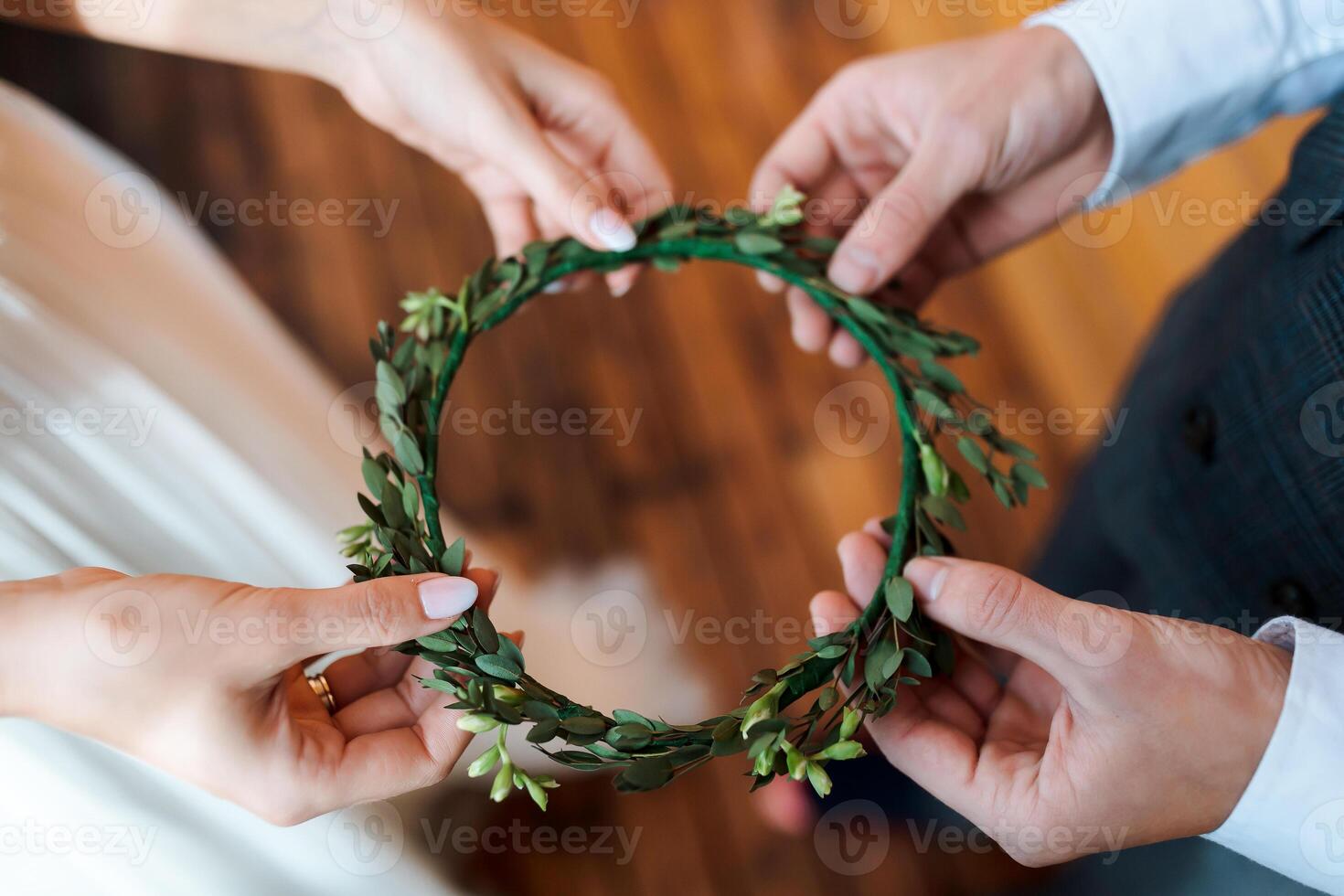 bride's wreath of greenery and fresh flowers. Wedding in a rustic style, details of the bride. Preparation for the wedding photo