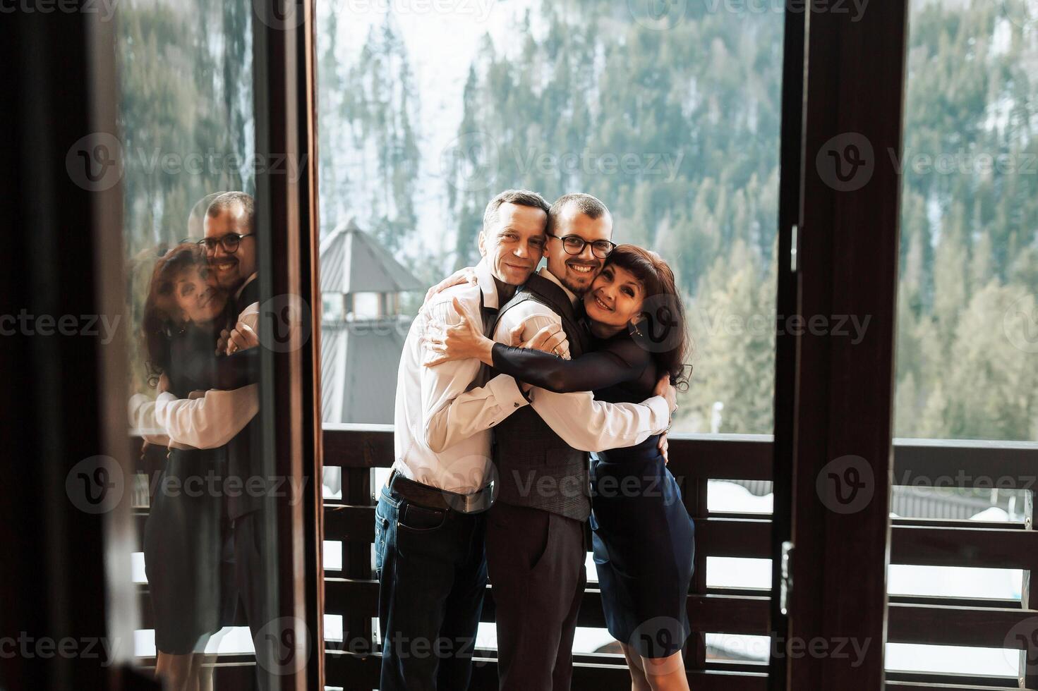 photo with parents at the wedding. Happy parents rejoice for their son who will soon get married. Touching moments at the wedding