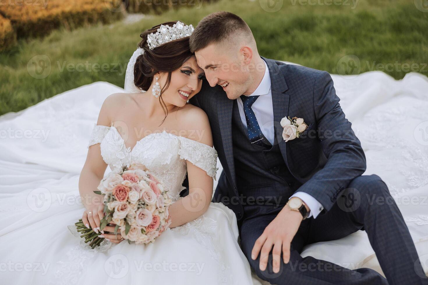 Wedding. Love and couple in garden for wedding. Celebration of ceremony and commitment. Save the date. Trust. The bride and groom embrace. The groom embraces the bride under a spring flowering tree. photo