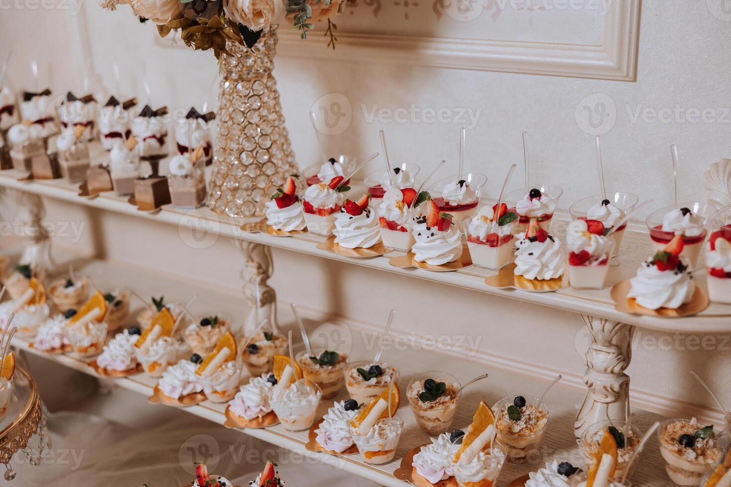 Almond cookies and various sweet cakes for a wedding banquet. A delicious reception, a luxurious ceremony. Table with sweets and desserts. Delicious colorful French desserts on a plate or table. photo